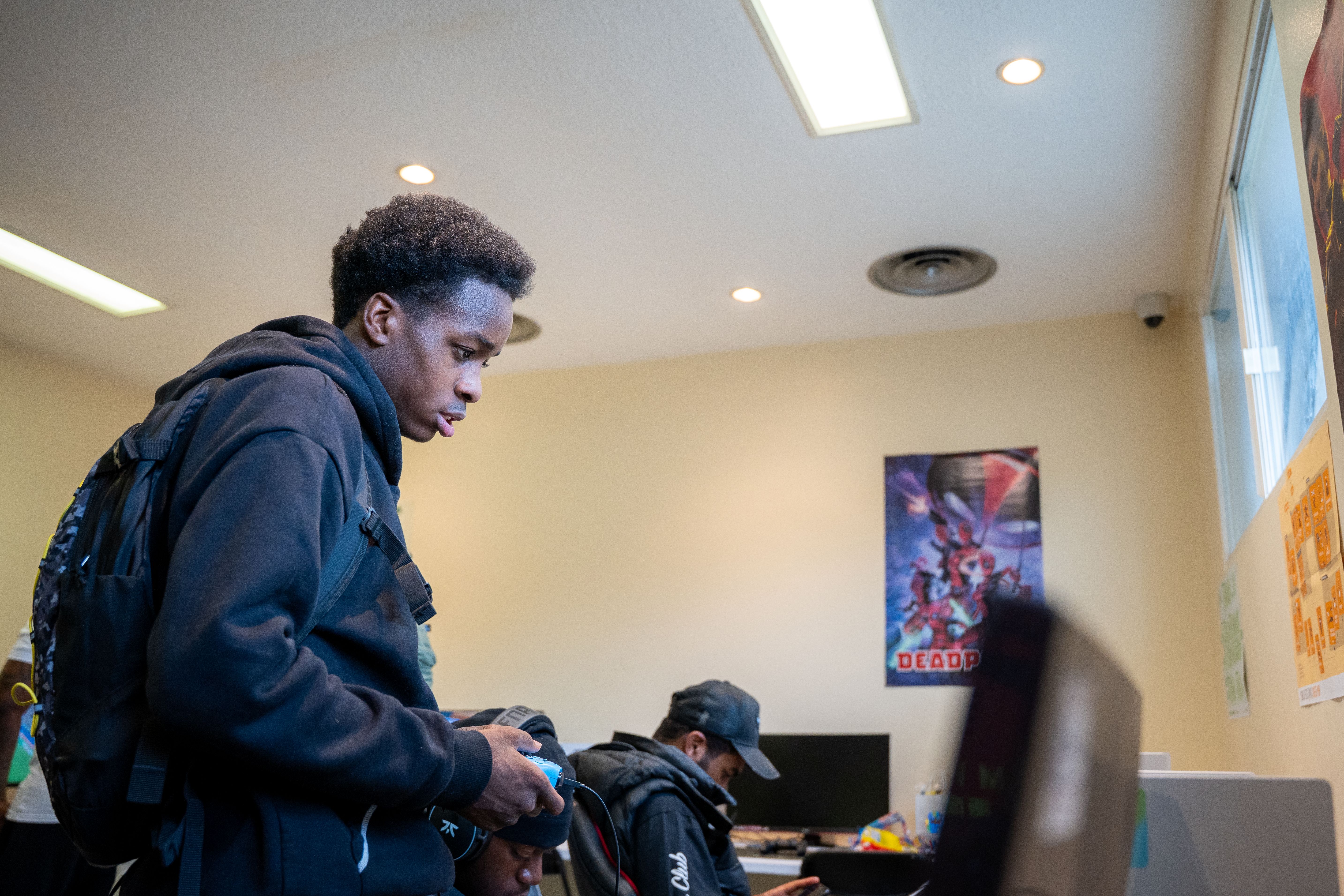 Young person concentrating while playing a console game at The Next Level gaming takeover.